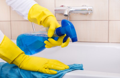 Technician performing upholstery cleaning on a fabric armchair
